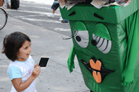 child interacting with green bin character