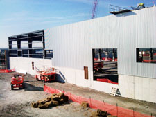 image: Aluminum composite panels are attached to the outer frame of the bale building