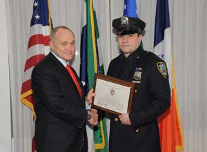 Police Commissioner Kelly presing Police Officer Jose Diaz with a certificate - click here for full size