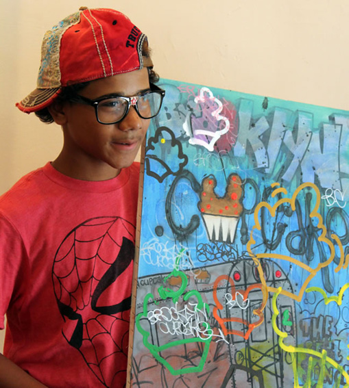 A participant in the Paint Sraight program displays his work
