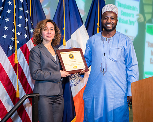 Commissioner Meera Joshi honors Safe Driver Honoree and ceremony speaker Ali Abubakar.