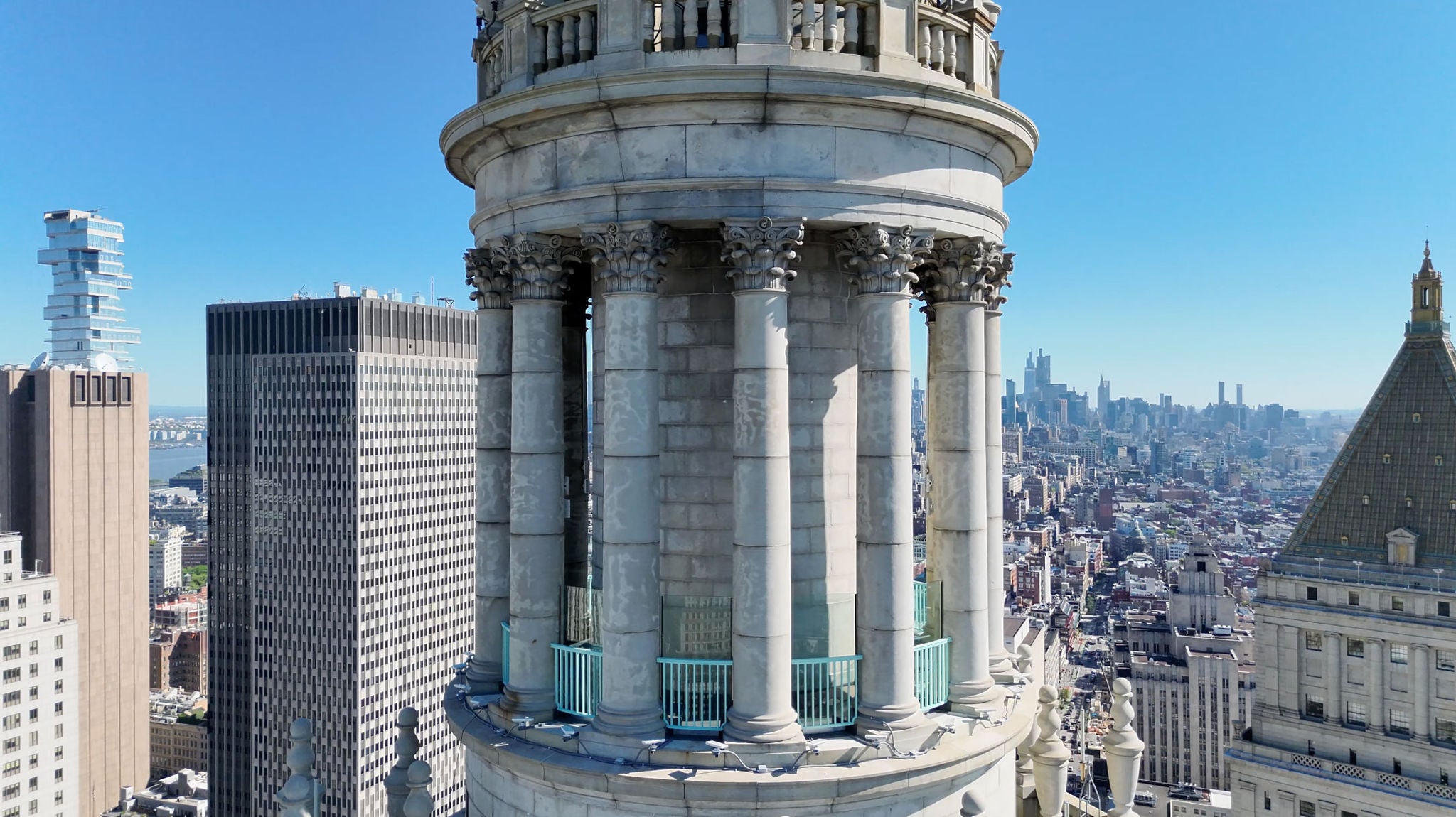 Aerial shot of the 1 Centre St. cupola with a view of uptown in the background
