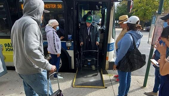 Photo of person using accessible MTA bus.