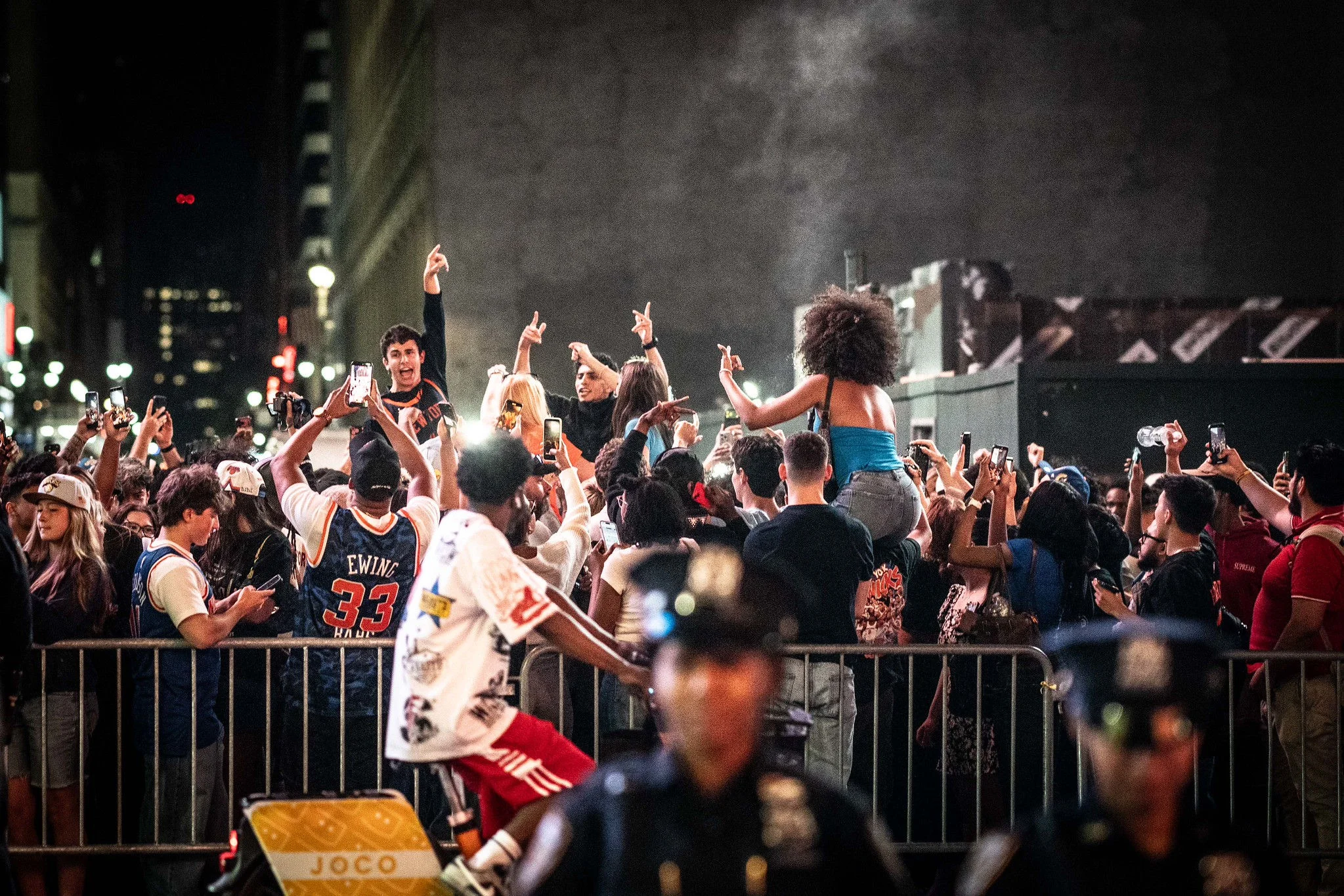 Photo of Knicks fans with NYPD officers in the foreground.