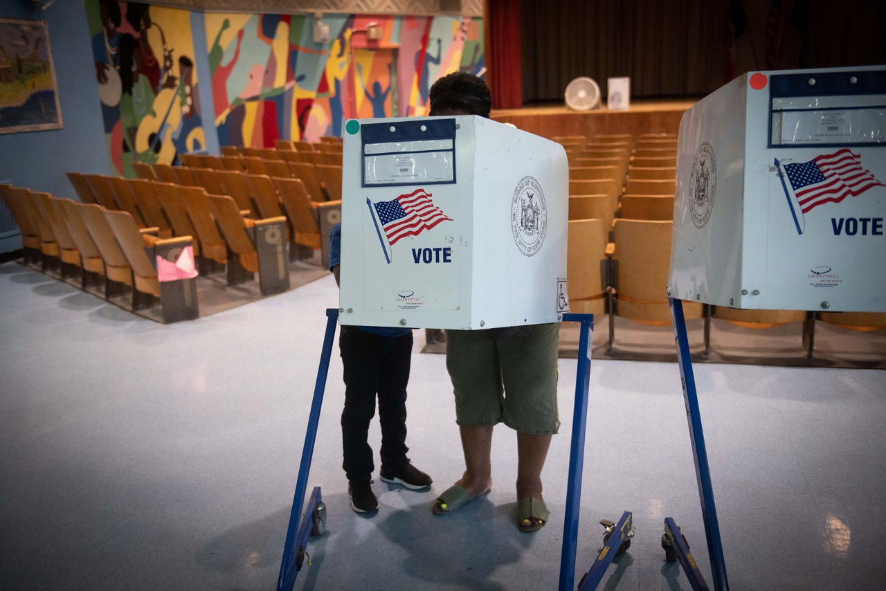 Voters casting ballots in polling station