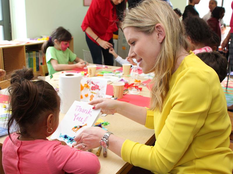 NYFC volunteer Hana Bitton doing craft activities with a child at the ACS Children’s Center