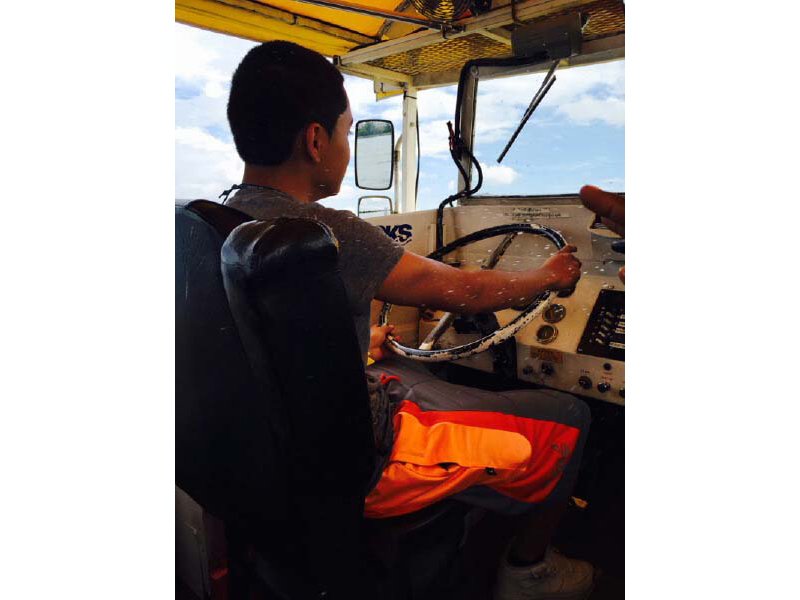 One of the boys navigates a boat on the Potomac River