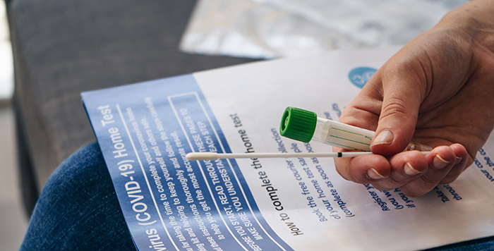 Hand holding an at-home COVID-19 test