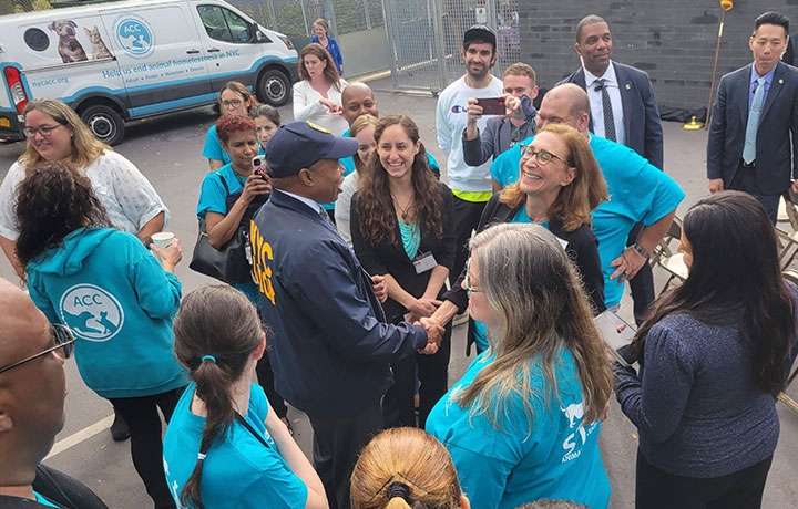 mayor adam is shaking hands with animal care center ceo
                                           