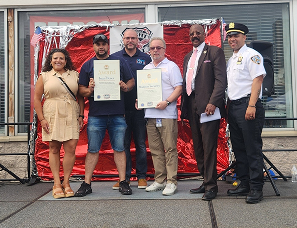 District Manager William Rivera (middle left) two constituents with an award alongside Senator Fernandez (far left) and Officer Moya (far right).
                                           