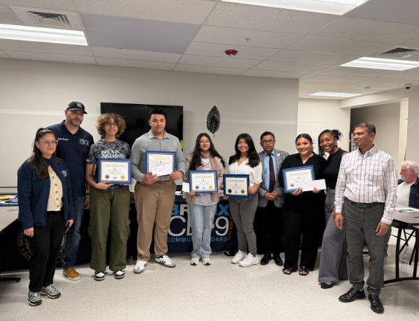 Yankee Youth Award Recipients presented with awards and checks alongside Bronx Community Board 9 staff and board members.
                                           