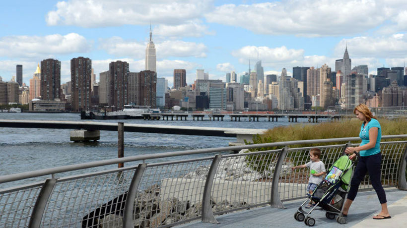woman with son and stroller in front of East River Waterfront
                                           
