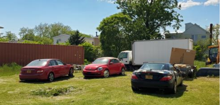 Photo of illegally using the premises as a contractor’s yard and for dead and commercial vehicle storage.