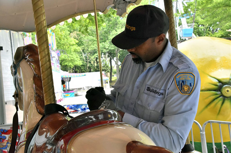 An inspector looking over a Merry Go Round