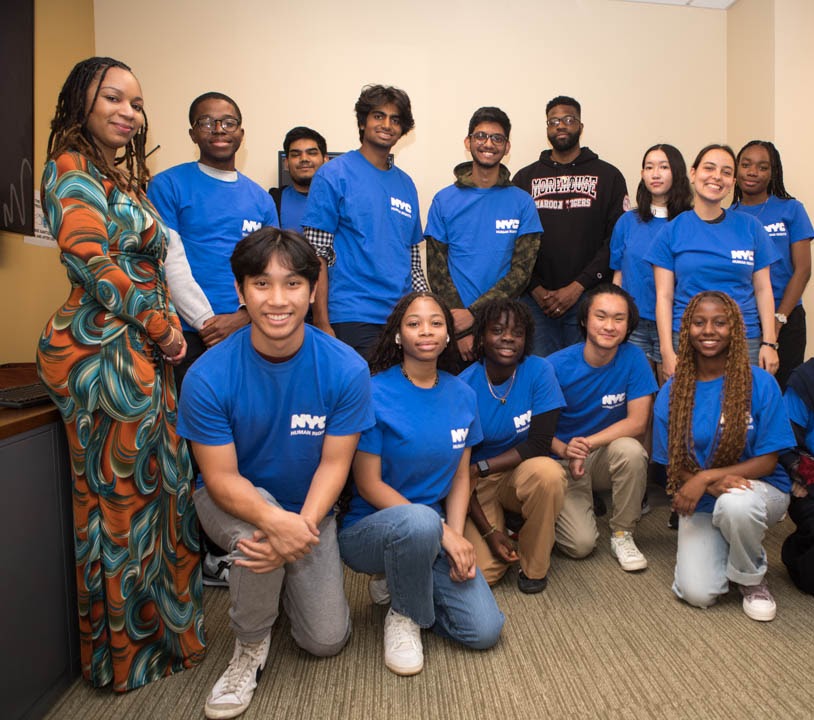 Group of young people with Commission staff members posing for camera holding up a banner that reads “Intermediate School 291 Celebrates Respect for All Week.”