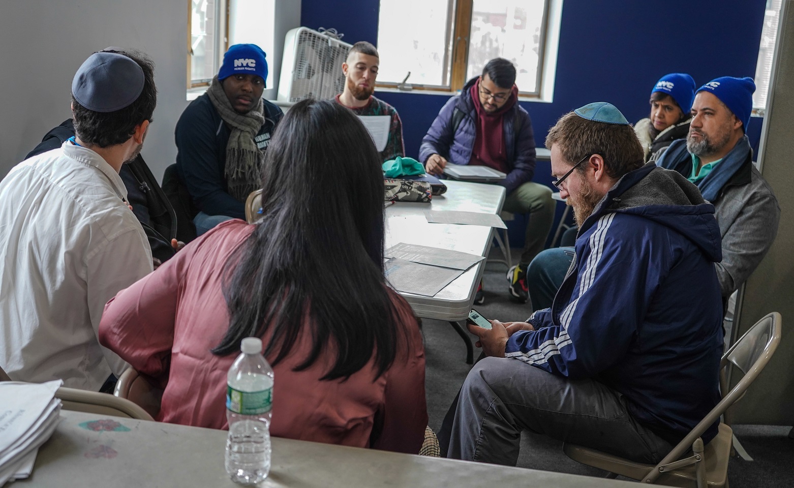 Commission staff and community advocates sitting around a table.