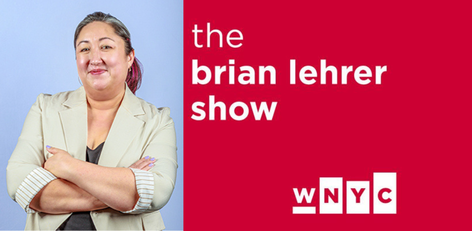 Commissioner Christine Clarke, with her arms crossed, wearing a light blazer, stands against a blue background. Next to her, a red panel reads The Brian Lehrer Show with the WNYC logo displayed below.
