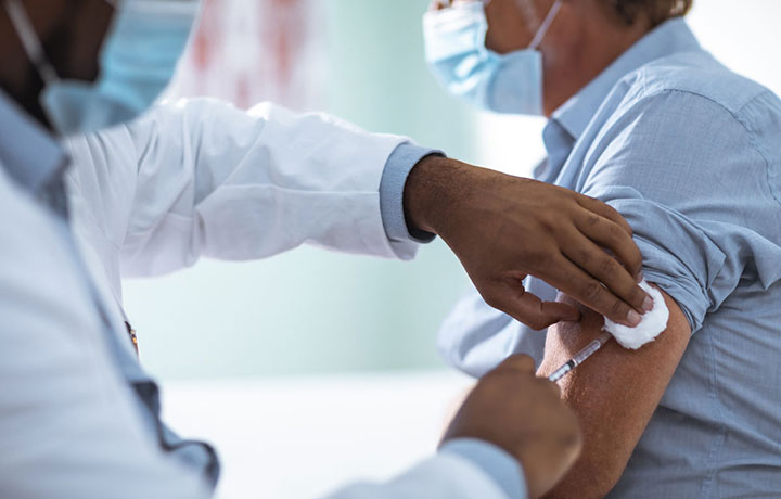 Man getting a vaccine shot
                                           