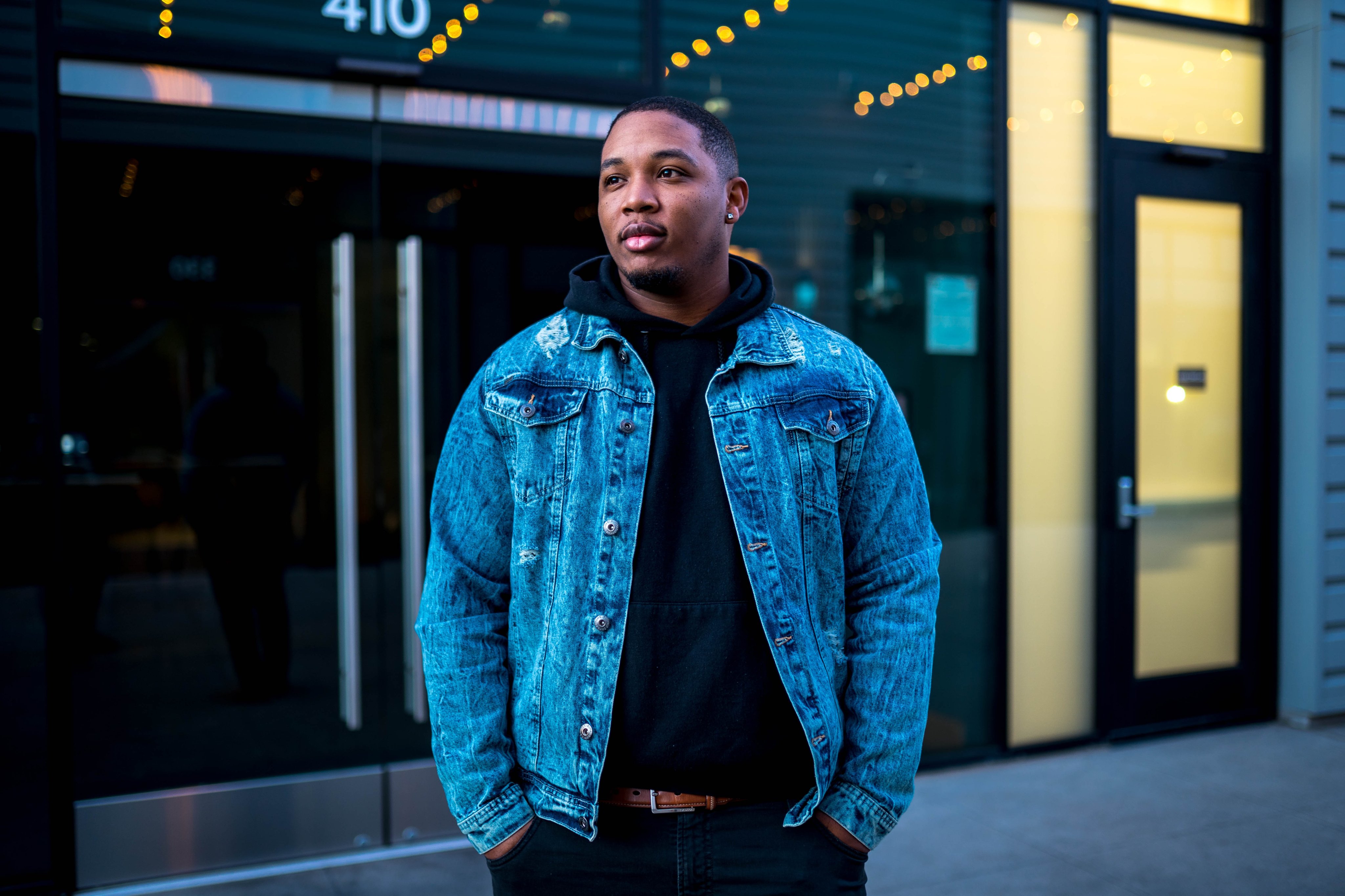 African American man standing in front of storefront
                                           