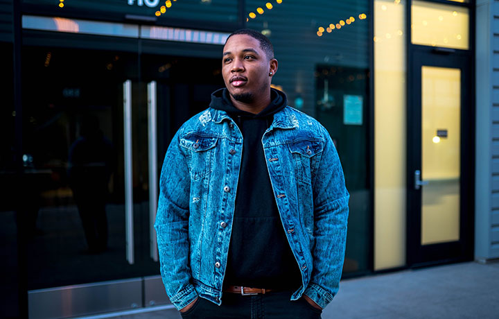 African American man standing in front of storefront
                                           