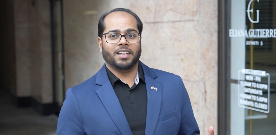 Why I Joined the Community Board - Man speaking outside an office building, gesturing with his hands while addressing the camera.