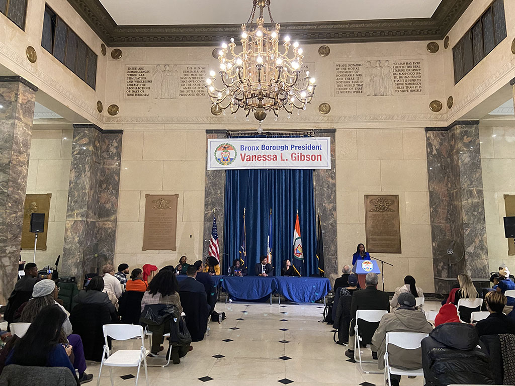 Bronx Borough Hall Rotunda full of people and panelists during civics summit
