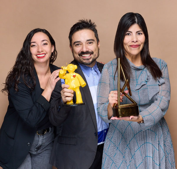 The Sunnies" wins Bronze at the Anthem Awards 
"Three individuals from the Civic Engagement Commission posing with bright smiles, holding the award. One holds a yellow figurine, the Sunnies, with a heart symbol, and another holds the award." 