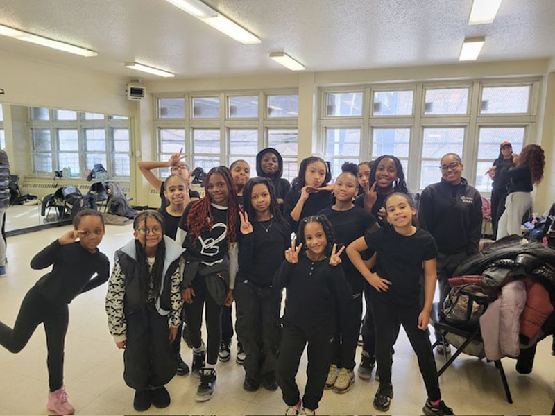 This image shows a group of youth posing for a photo that are involved in the Youth Activity and Enrichment Program with the Arts program that the Kips Bay Boys and Girls Club is implementing