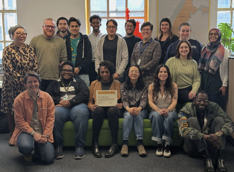 This photo contains the CEC staff sitting on a couch in the office – Happy to have received the Service Recognition award
