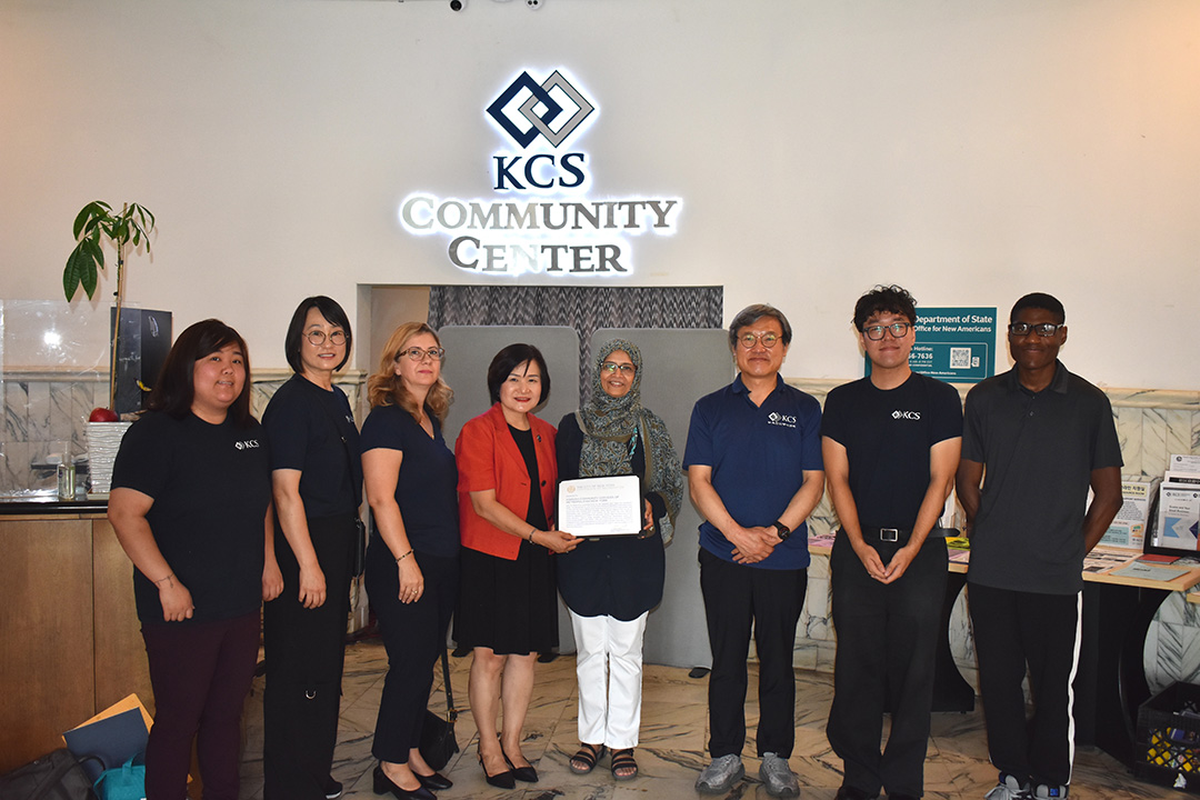o	Group photo of Sarah Sayeed, Anila Cobo, and staff from Korean Community Services holding a certificate at the KCS Community Center.