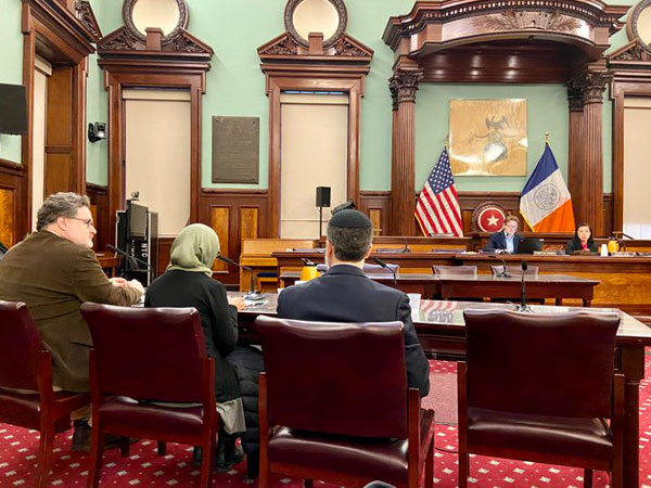 CEC Chair & Executive Director Dr. Sarah seated, testifying at the court room