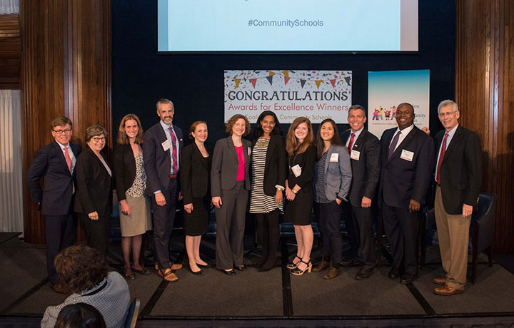 the awards for excellence winners stand on stage and pose for a picture
                                           
