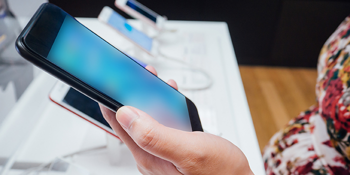 consumer shopping for smartphone in a store