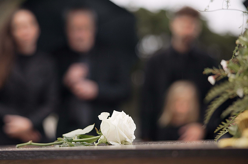 Photo of a grieving family during funeral service
                                           