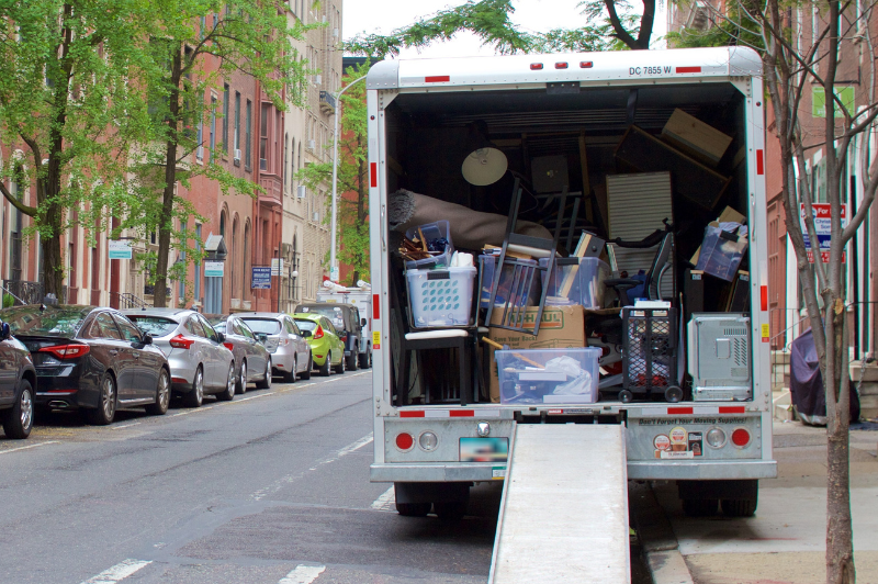 Moving truck on city street with furniture inside
                                           