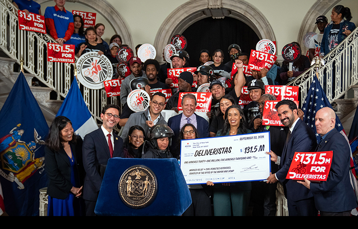 Mayor Mamdani shows large check for $131.5 Million with DCWP Commissioner Sam Levine, Deputy Mayor Julie Su, Council Member Harvey Epstein, and members of Los Deliveristas Unidos
                                           