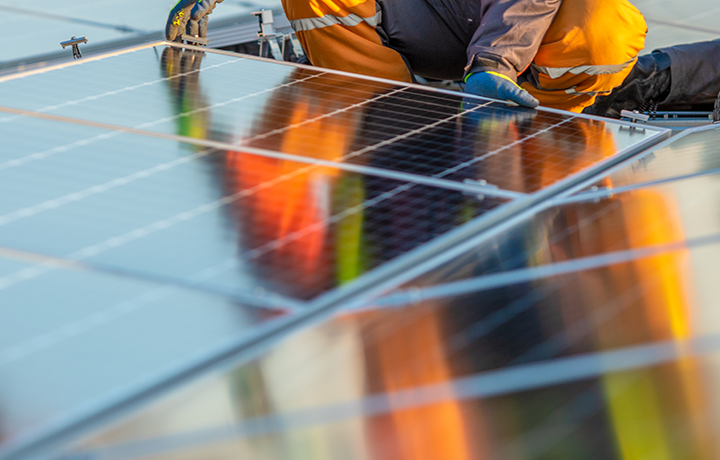 Contractor installs solar panels on a roof
                                           