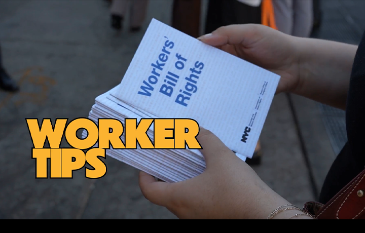 Hands hold up a copy of the Workers' Bill of Rights
                                           