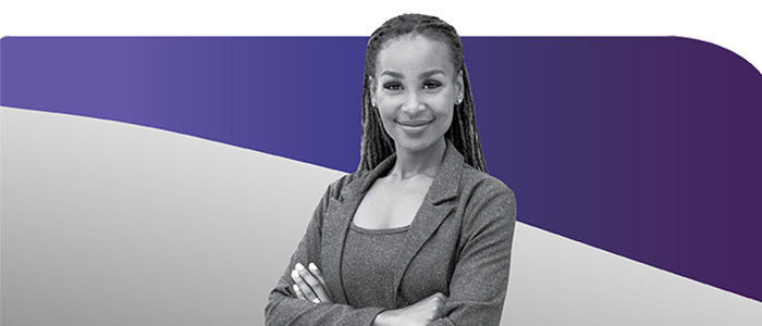 Woman with braids smiling with arms folded