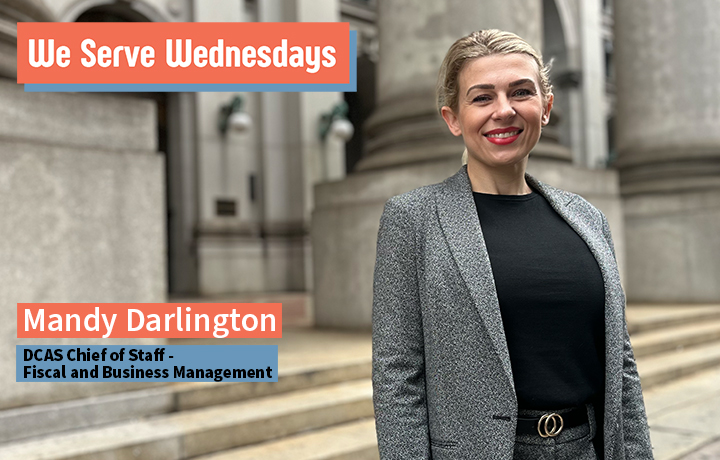 Mandy Darlington posing outside of 1 Centre Street in a grey blazer.
                                           