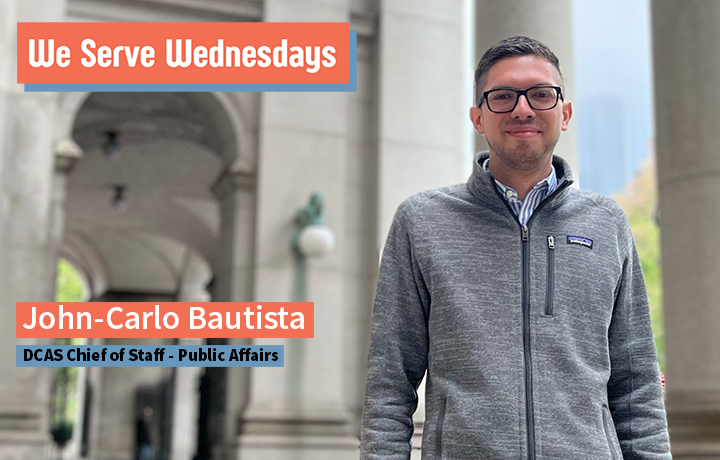 John-Carlo Bautista poses outside of the Municipal Building at 1 Centre Street, wearing a gray fleece jacket and glasses.
                                           