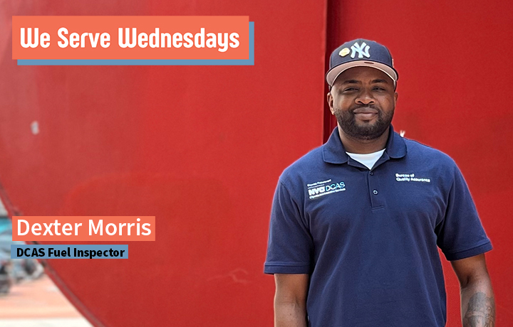 Dexter Morris stands in front a red statue outside, wearing a blue DCAS polo.
                                           