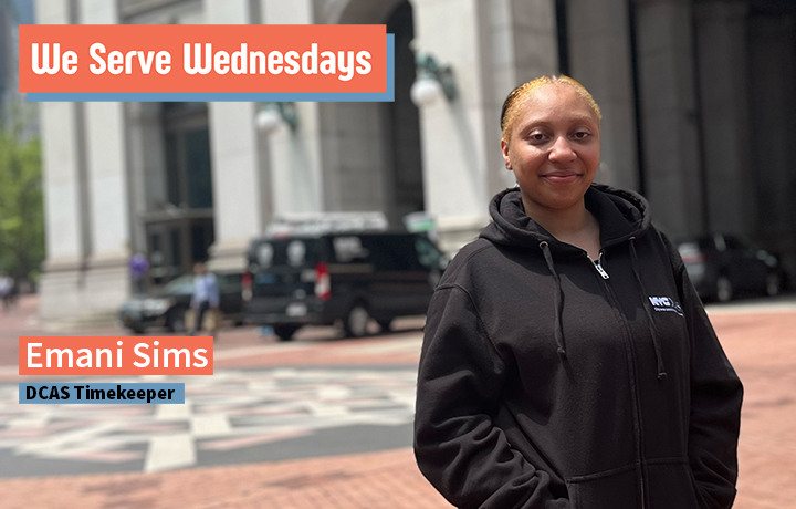 Emani Sims poses in front of 1 Centre Street in a black DCAS Hoodie.
                                           
