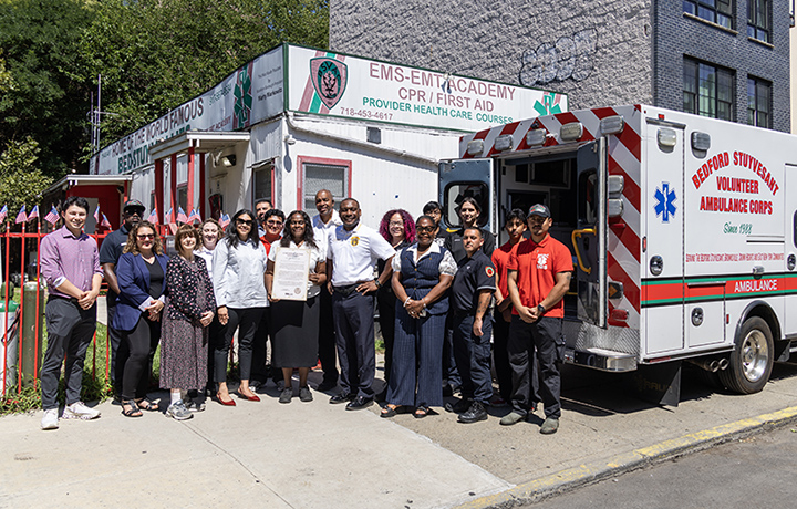 DCAS, BSVAC representatives and state officials pose in front of volunteer ambulance.
                                           