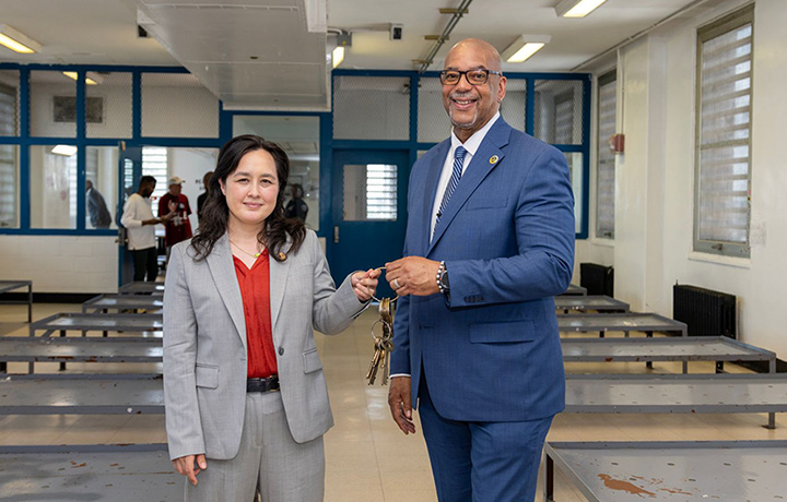 Department of Citywide Administrative Services (DCAS) Commissioner Yume Kitasei accepts keys from Department of Correction (DOC) Commissioner Stanley Richards to mark the transfer of Rikers facilities to DCAS.
                                           