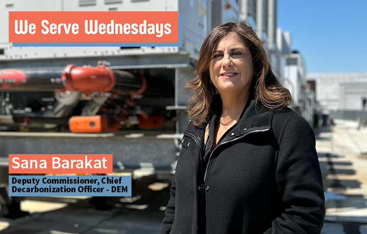 Woman standing outside on a roof with h v a c equipment behind her. 
                                           