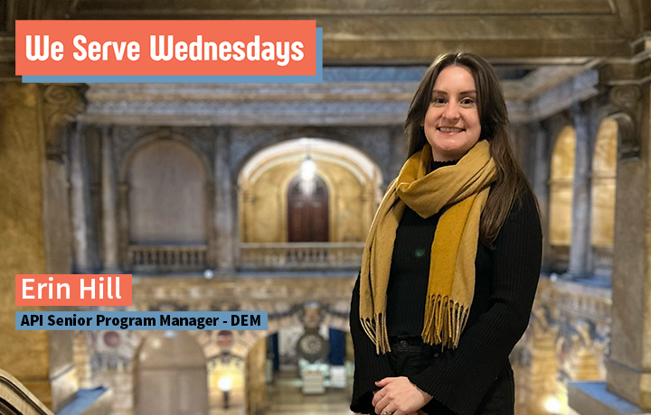 A woman wearing a scarf standing on an upper level of Manhattan Surrogate's Court.
                                           