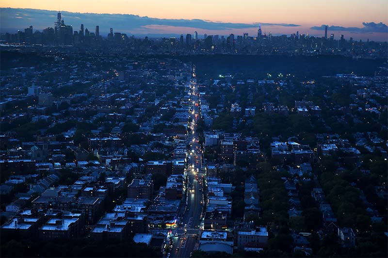 Sunset on a darkened city witht he NYC skyline in the background. Photo credit to D. Freeman of the Mayoral Photography Office 