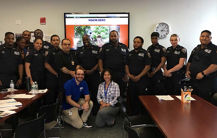 DCAS instructors and uniformed officers posing for a photo at a driving class.
                                           