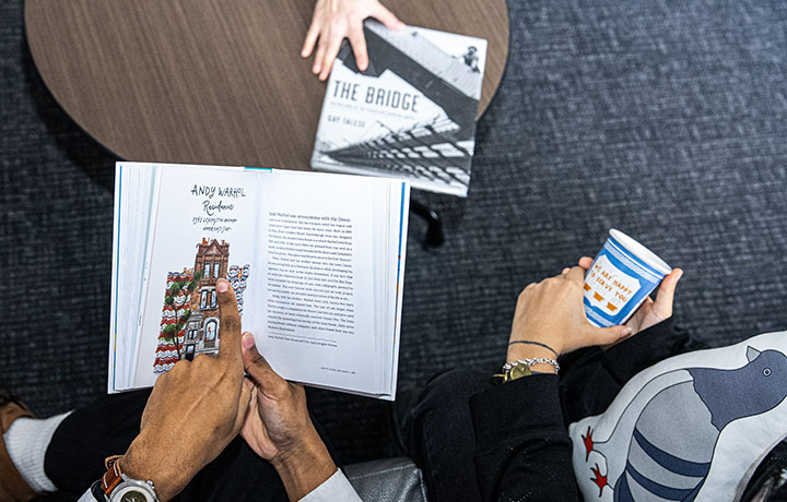 Two individuals at a table with items from the CityStore.